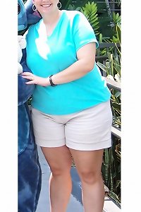 plump lady seductively posing while embracing herself